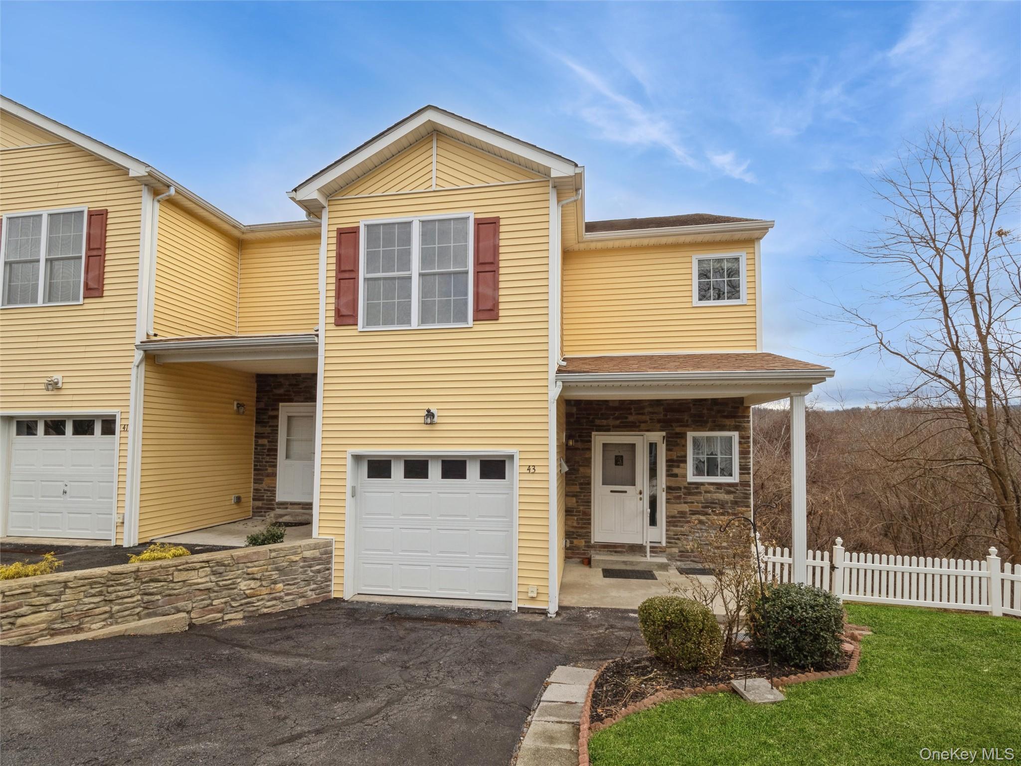Front of townhouse showing access to garage and entrance