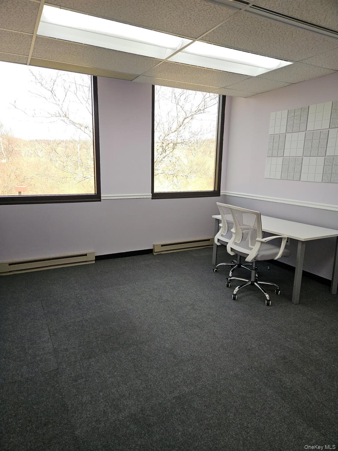 Unfurnished office featuring large windows
