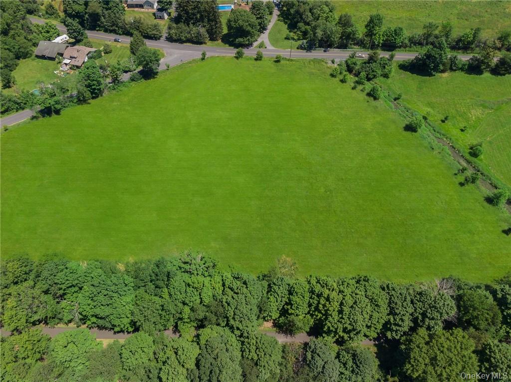 Looking approximately north, this large, cleared property as seen here (presently mowed for hay) is bordered by Duck Farm Road on left, Old Chester Road in the distance, the Heritage Trail corridor in the foreground, and is just left of the Otterkill seen