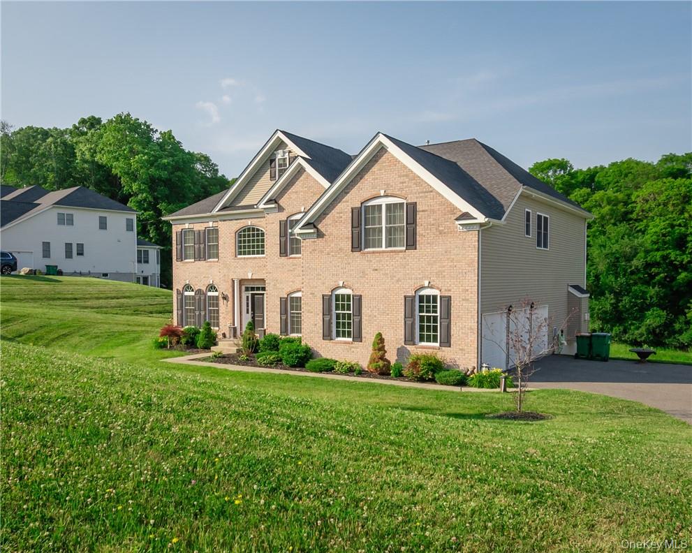View of front of house featuring a garage and a front lawn