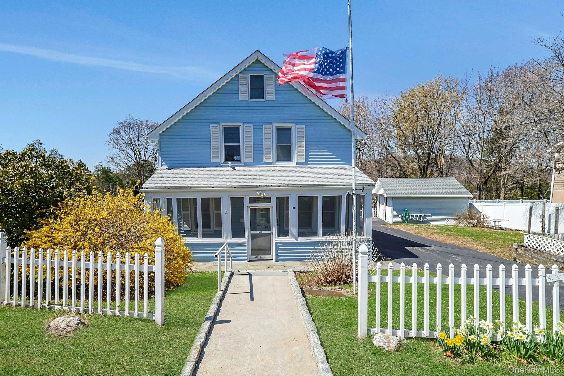Front view of property featuring a enclosed porch..
