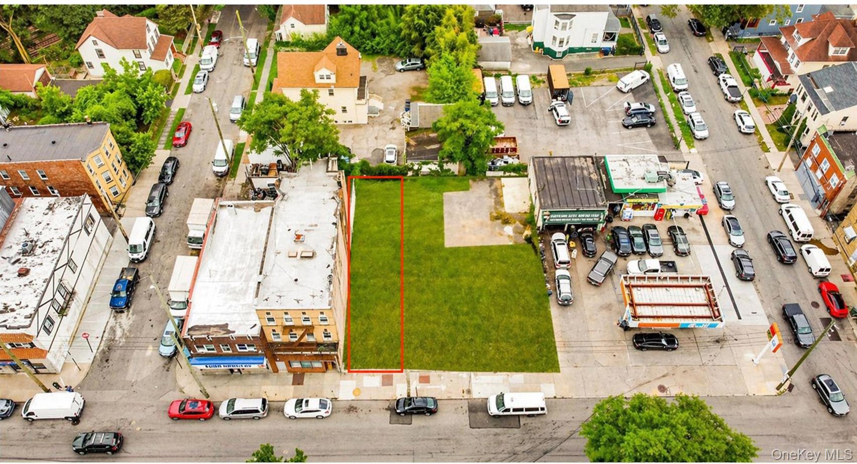 Expansive land parcel featuring a green lawn and direct street frontage