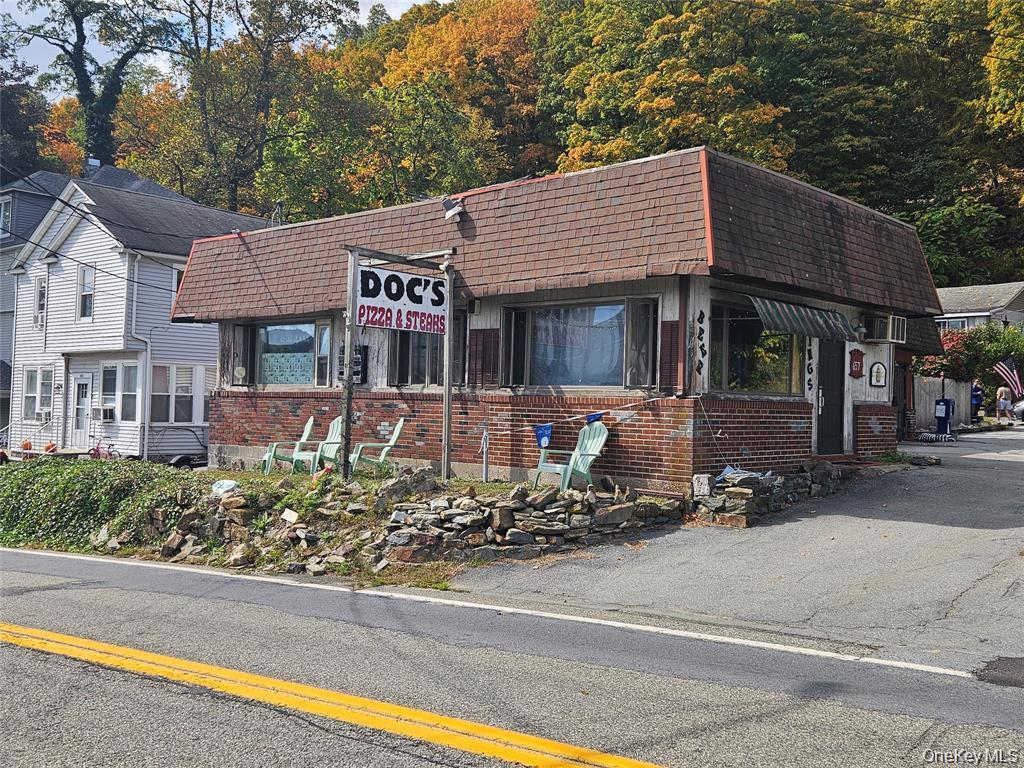 Commercial brick building, large front windows, and a prominent signage area