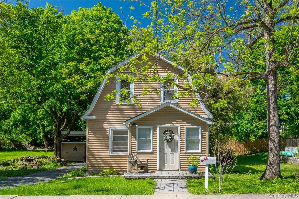 Two-story property featuring horizontal siding and a gambrel roofline