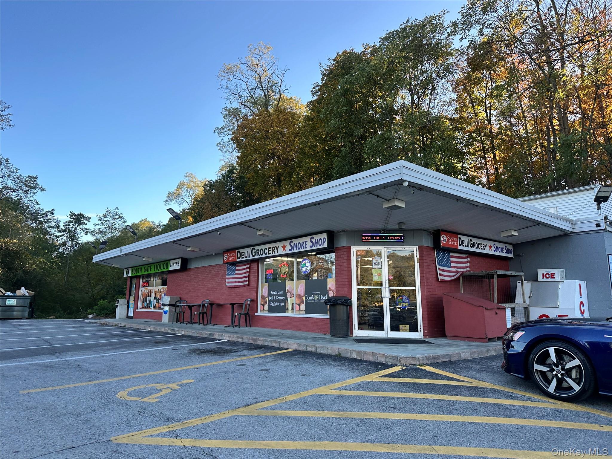 View of commercial location featuring uncovered parking