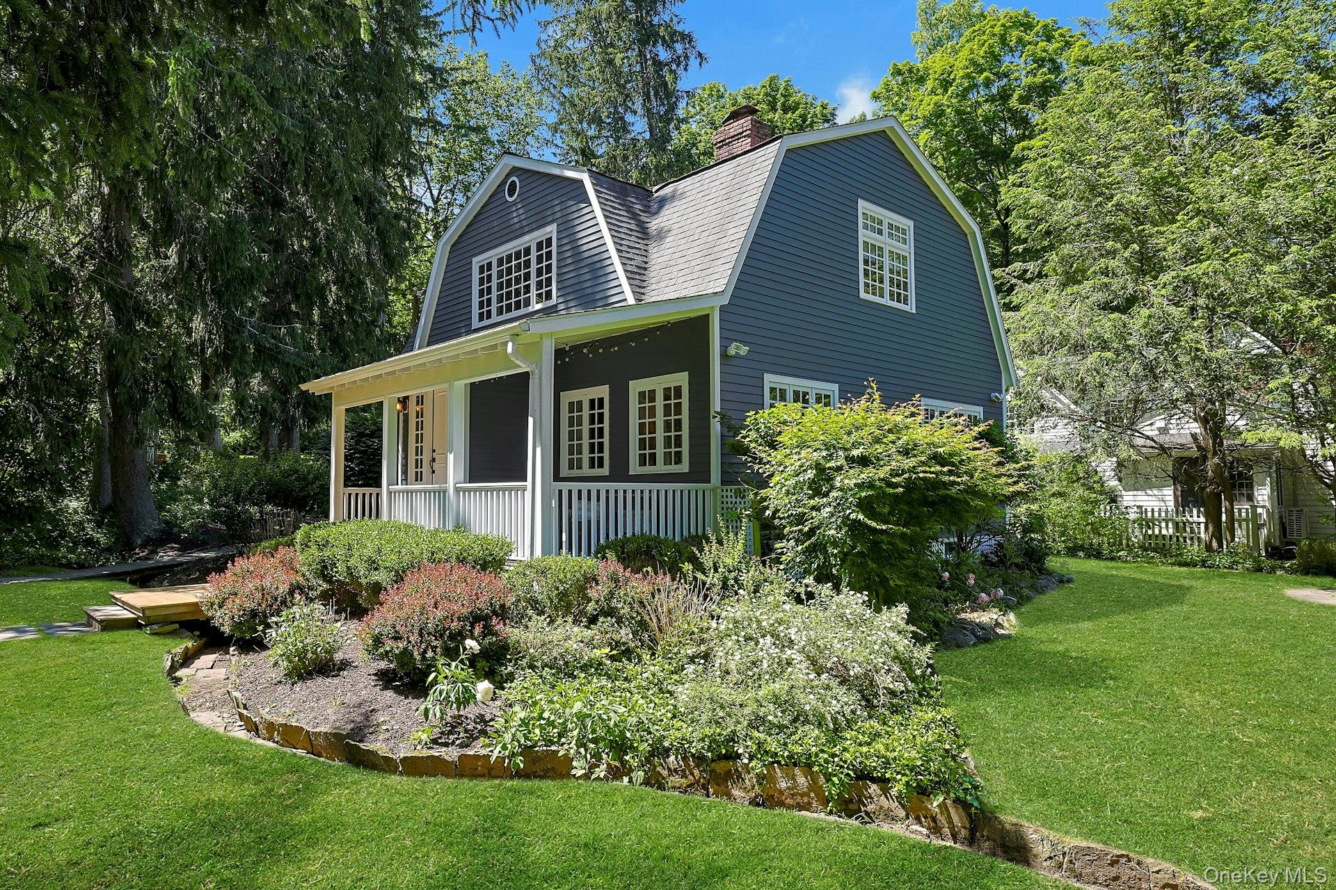 A beautiful view from the front of the property leads toward the backyard, showcasing the home’s inviting setting and the natural beauty that surrounds it.