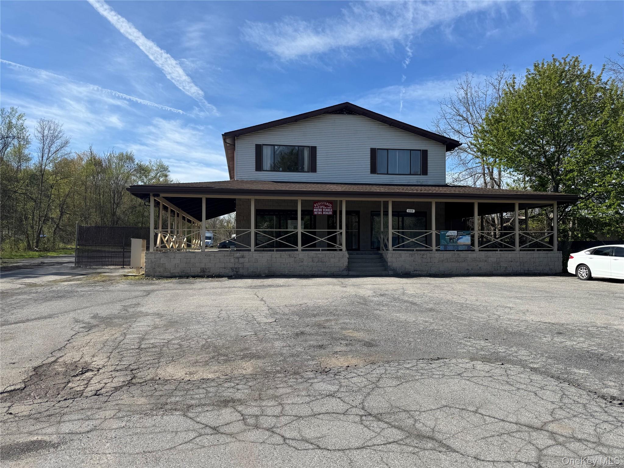 Two-story commercial building with a wrap-around covered porch