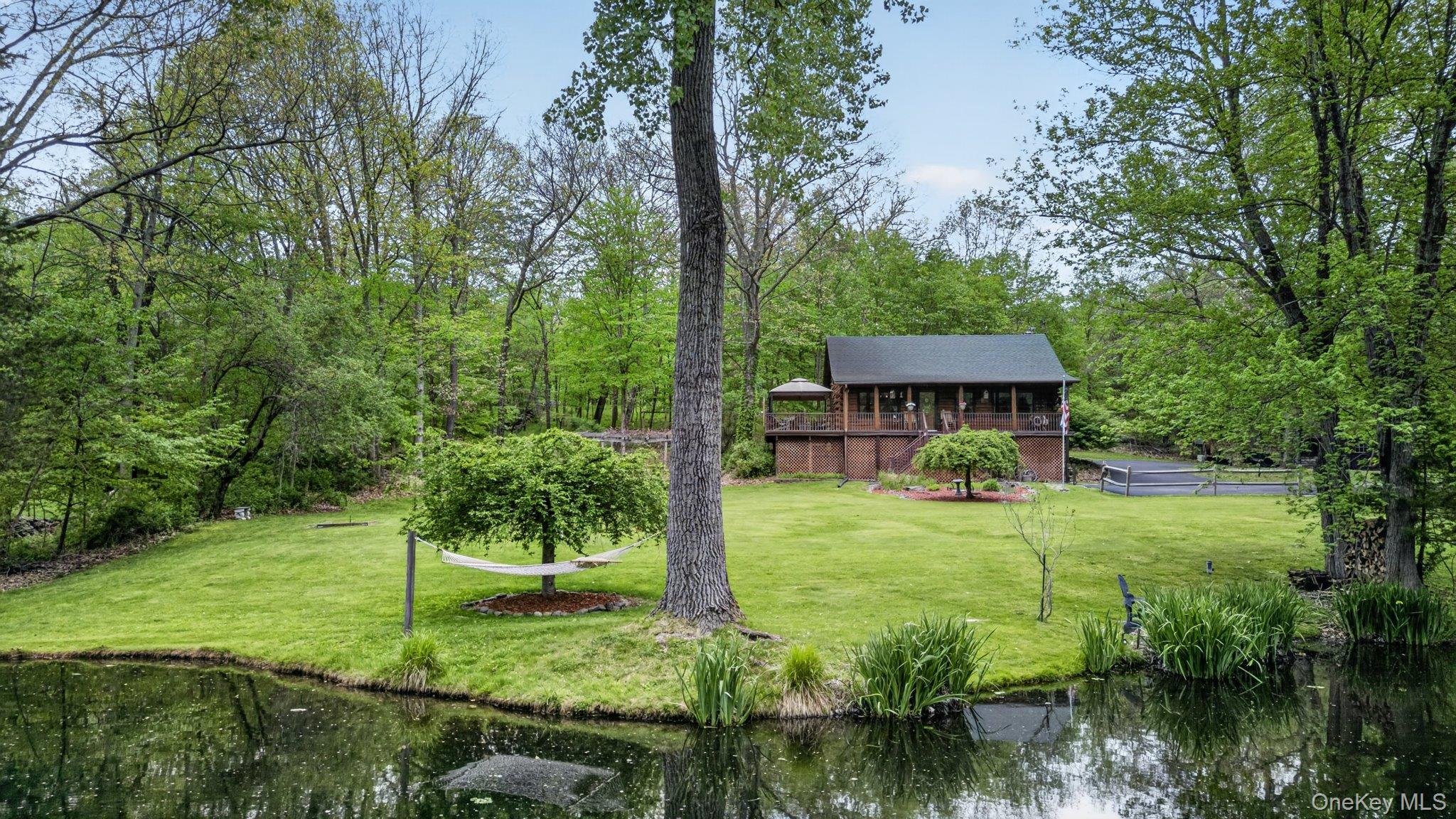 Your own slice of paradise; log cabbin with your own pond set on a cul-de-sac