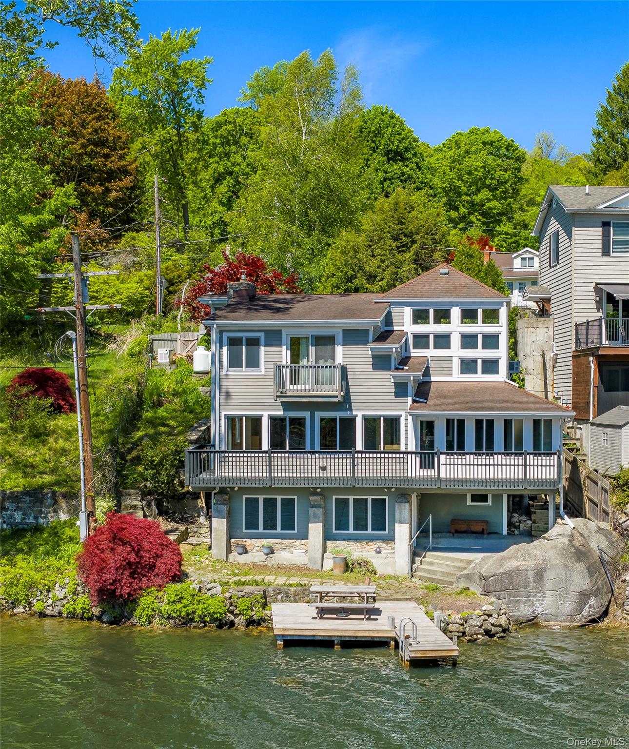 Lakefront property with private dock and adjoining protected land that preserves exceptional privacy and open space.