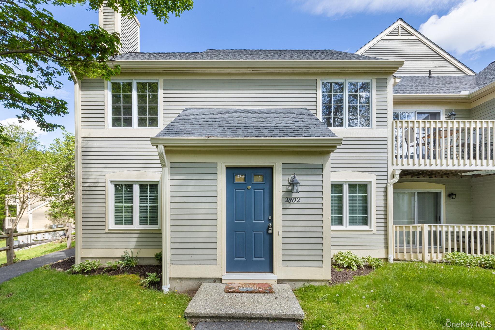 View of front of home with a chimney and a shingled roof