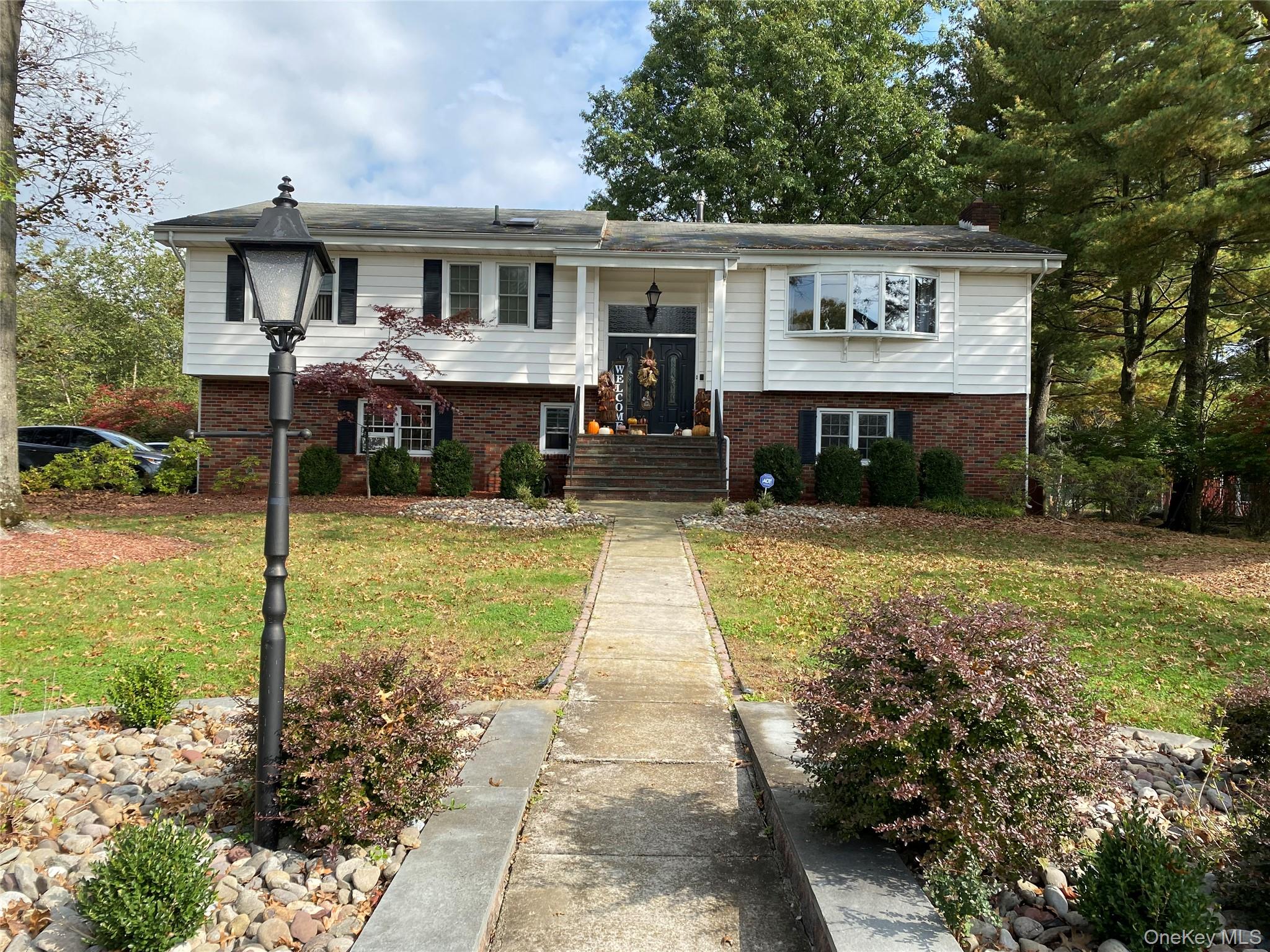 Raised ranch featuring a front lawn
