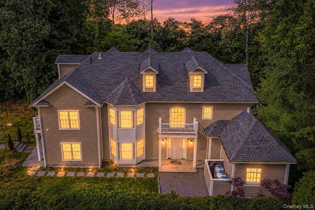 Grand residential exterior featuring multiple gables, dormer windows, and a prominent bay window