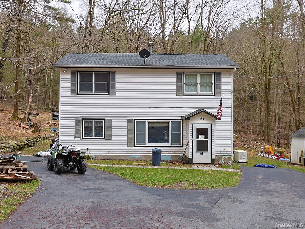 View of front of home featuring aphalt driveway