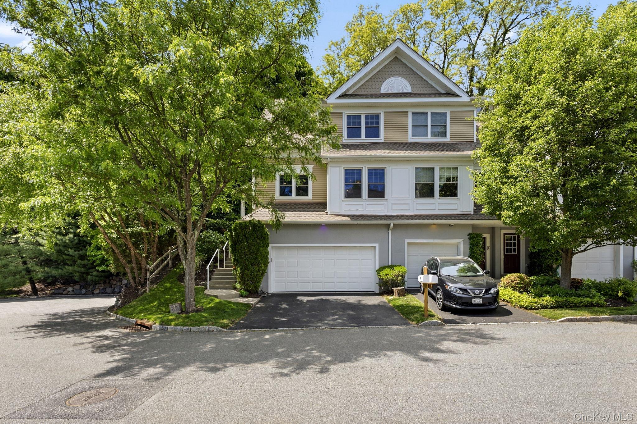 Front view of 94 Hillcrest, a desirable end-unit residence on the left featuring a spacious 2-car garage.