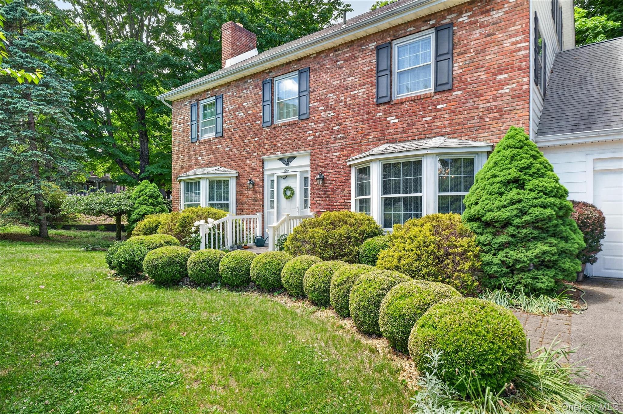 1 Taft - Welcome to Cornwall on Hudson - Brick exterior featuring a white entry door with side lights, multiple bay windows, and dark shutters