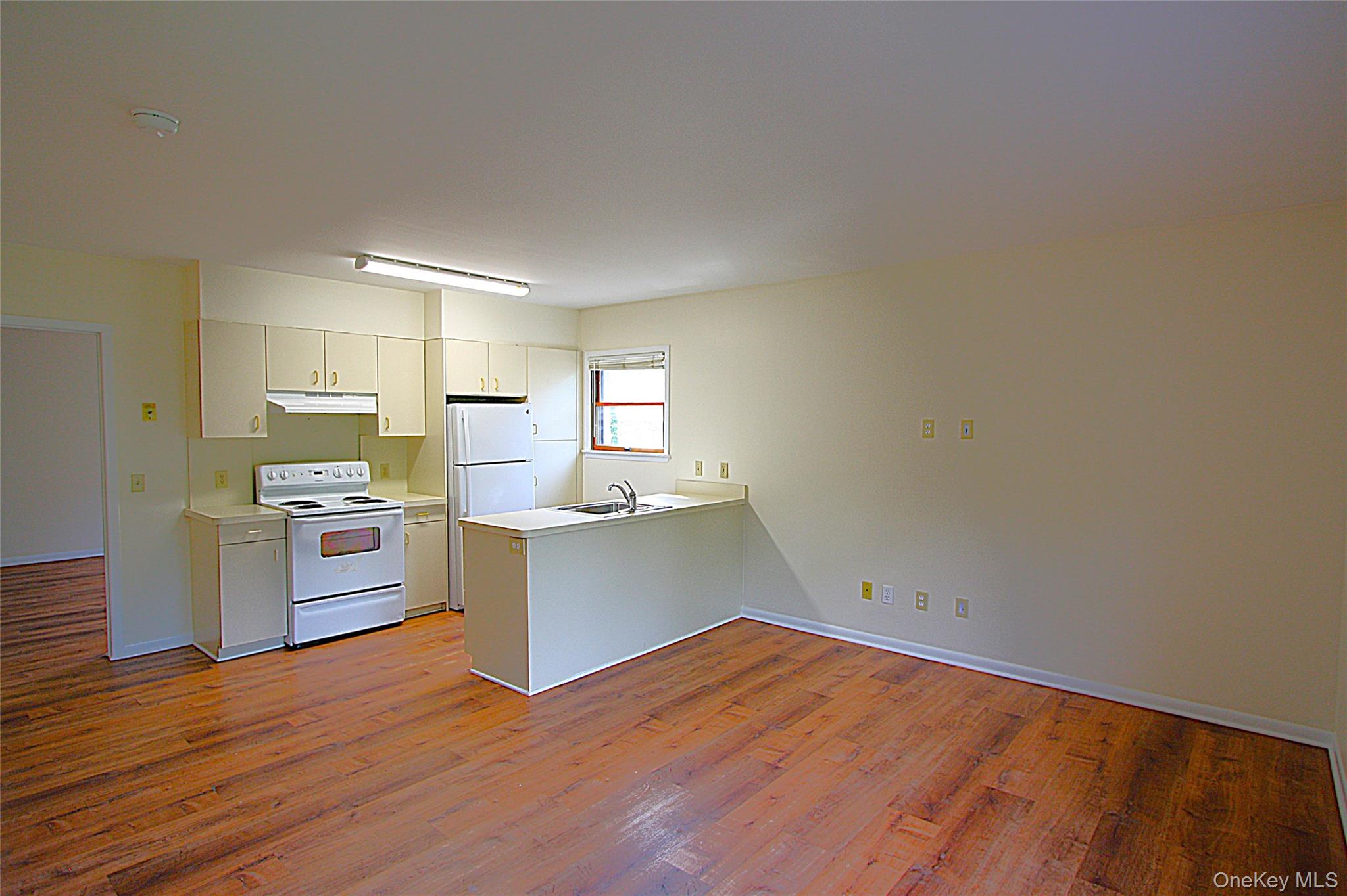 Welcome to 3115 Albany Post Road, Apartment 2. This unit has an open living room and kitchen.