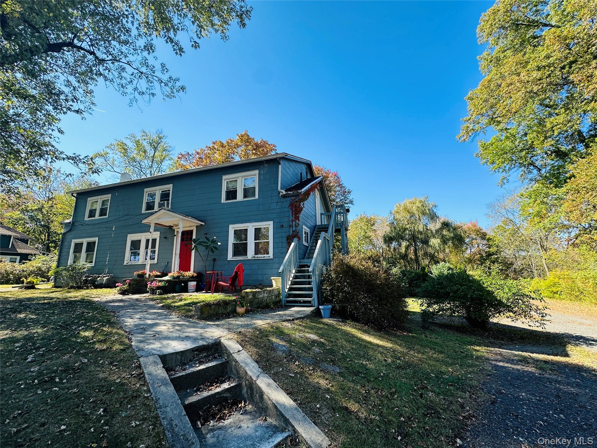 Two-story residence featuring blue siding and white trim