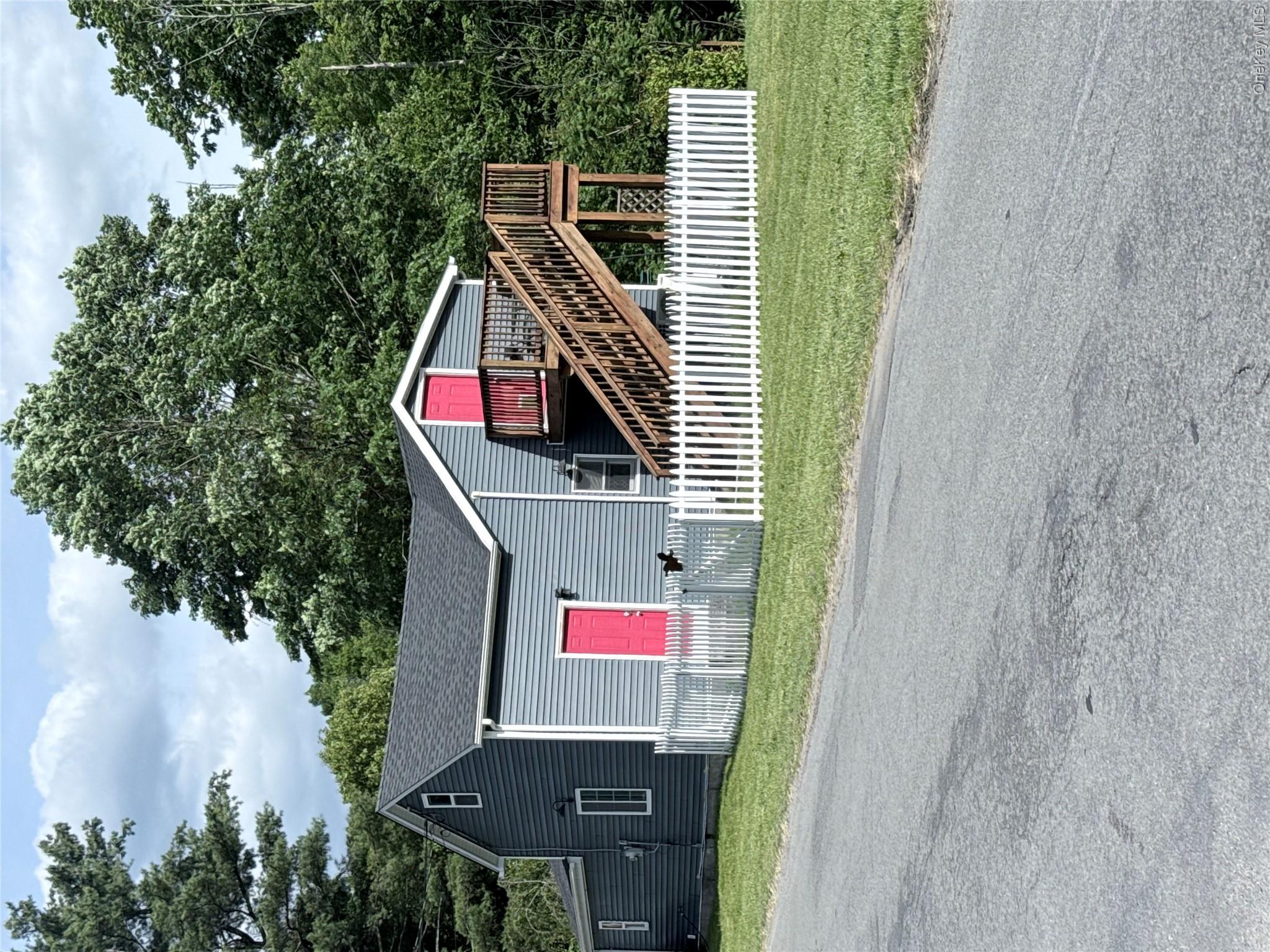 Gray siding exterior with contrasting bright pink doors