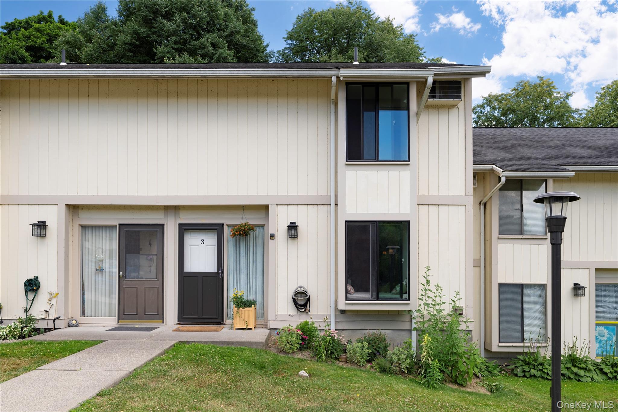 Light-toned vertical siding exterior with contrasting trim details
