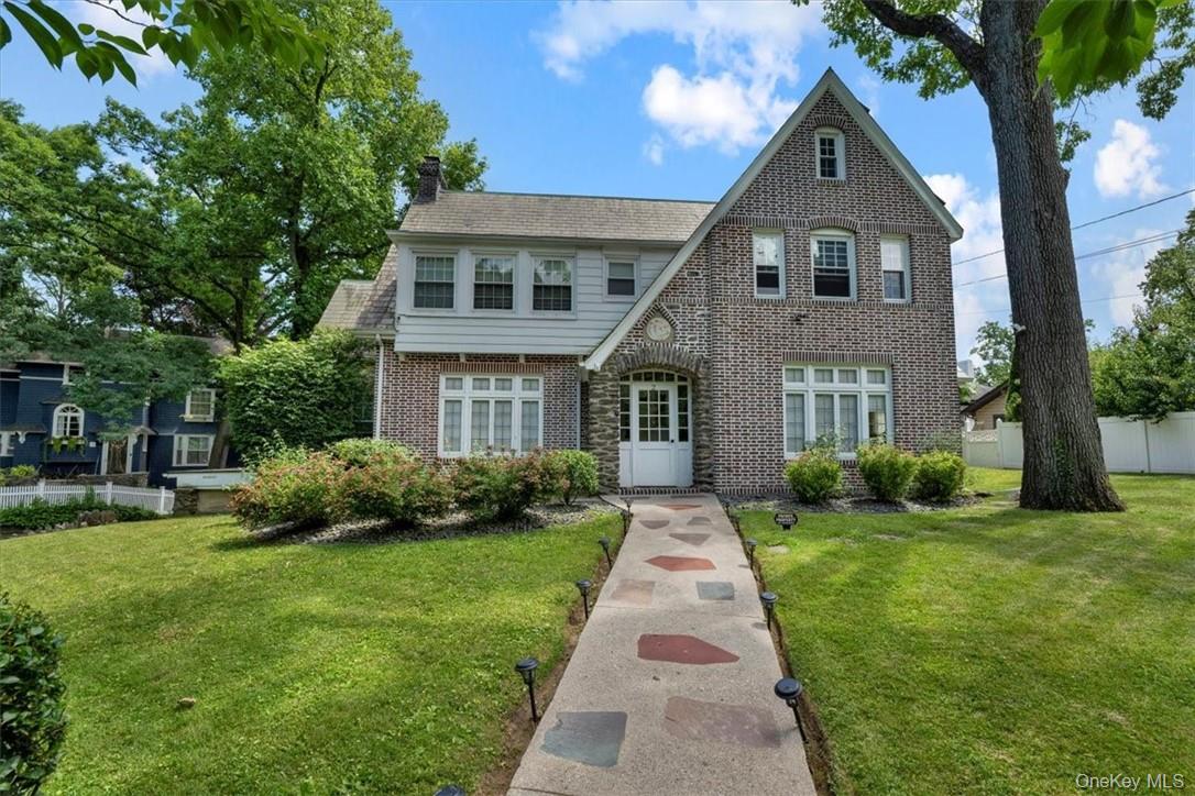 Tudor-style house featuring a front yard