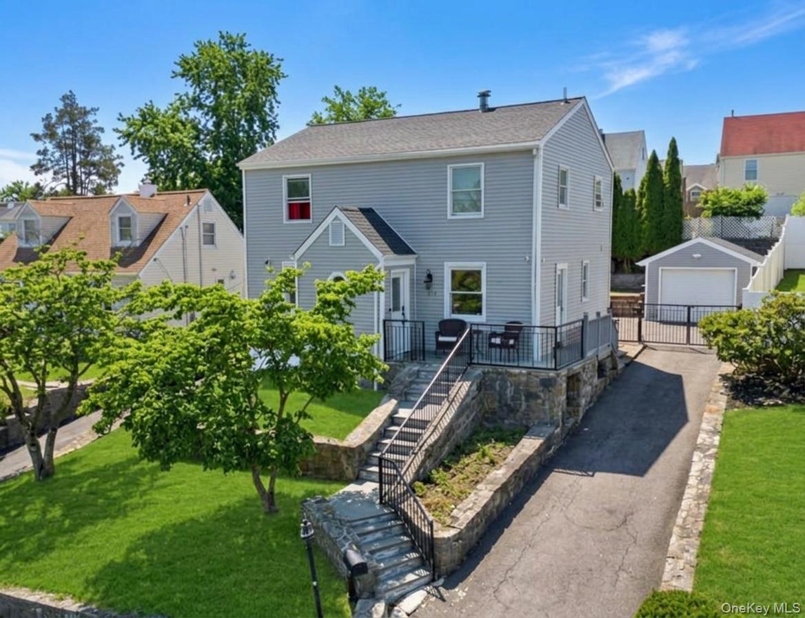 Two-story residence featuring light gray siding and a dark gray roof