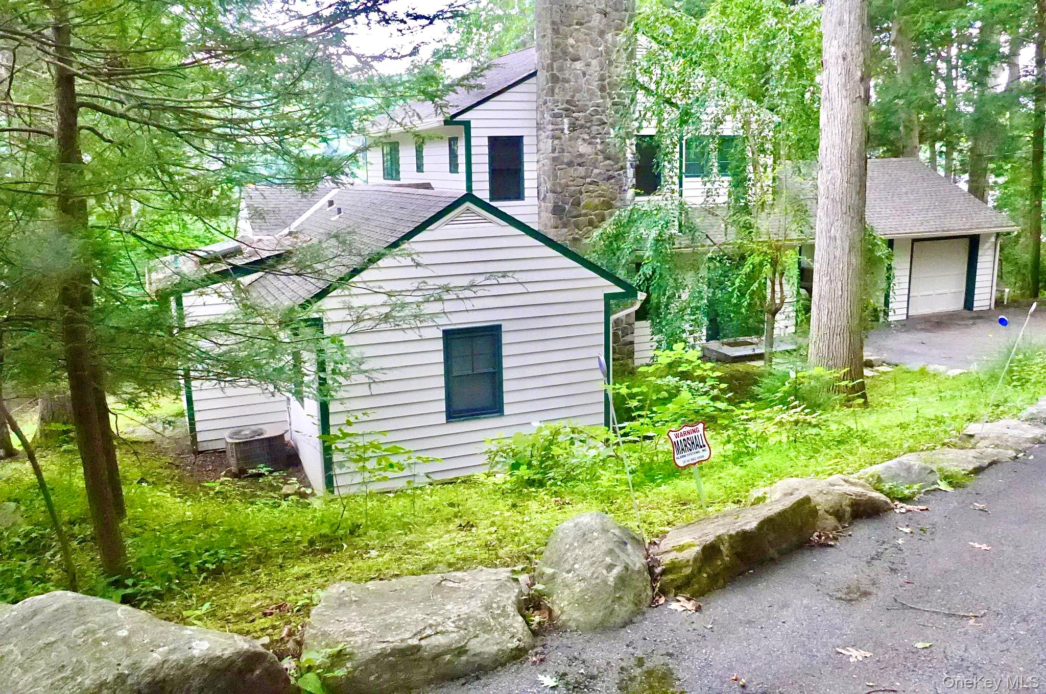 The home has two private bedrooms downstairs, and two up, with an open-plan kitchen, dining, and living area with views of the lake.