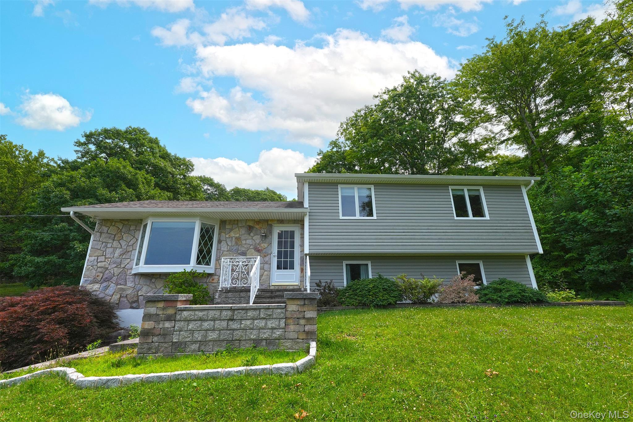 Welcoming Split Levelwith attractive Stone front and Large Angle Bay Window.